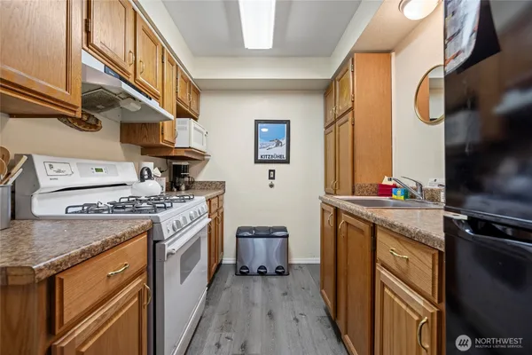 a kitchen with stainless steel appliances granite countertop a stove and a refrigerator