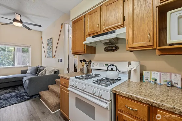 a kitchen with stainless steel appliances granite countertop a stove and a sink