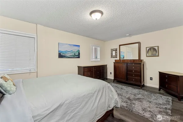 a bedroom with a bed and a television