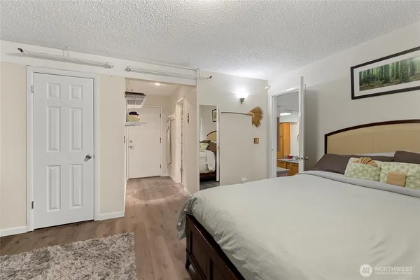 a bedroom with a large bed and a chandelier