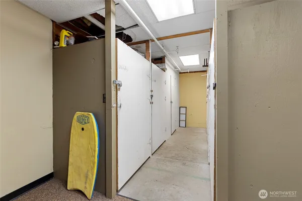 a view of a hallway with wooden walls