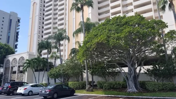 a couple of cars parked in front of building