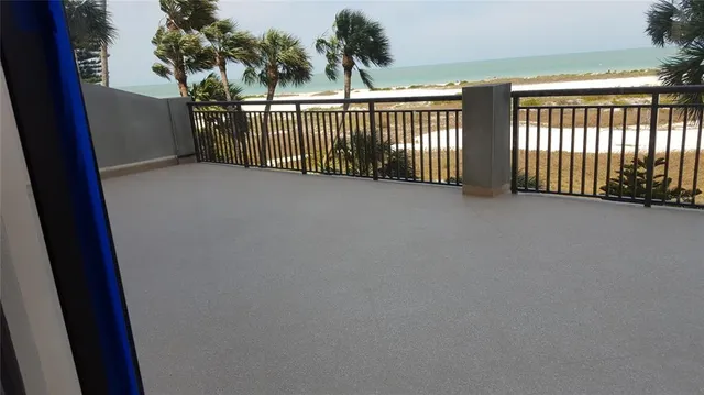 a bedroom with two beds and a lamp on dresser