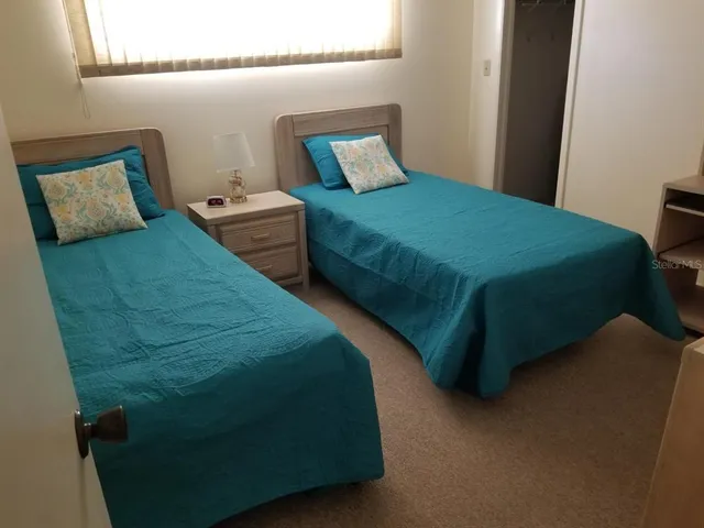 a bedroom with a bed and a potted plant