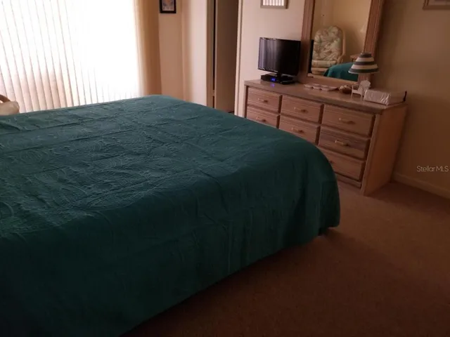 a bedroom with a bed and night stand