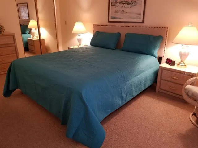 a bedroom with a bed and a dresser