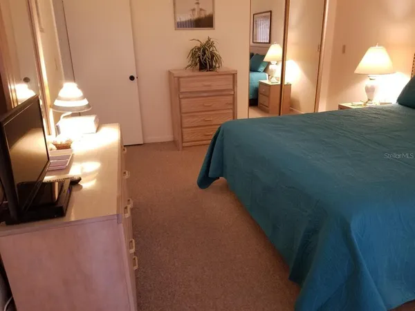 a bedroom with a bed and a lamp with window