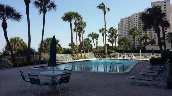 a view of a swimming pool with a table and chairs