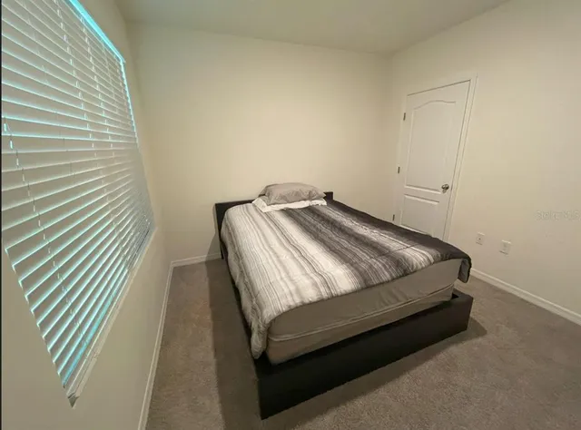 a bedroom with a bed and chair