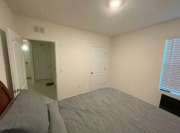 an empty room with wooden floor and a window