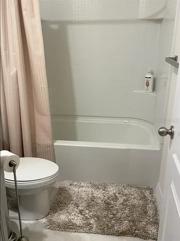a bathroom with a toilet and a bathtub