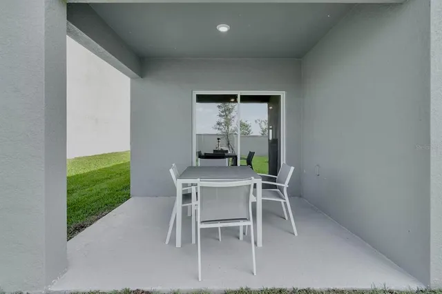 a dining room with furniture and a window
