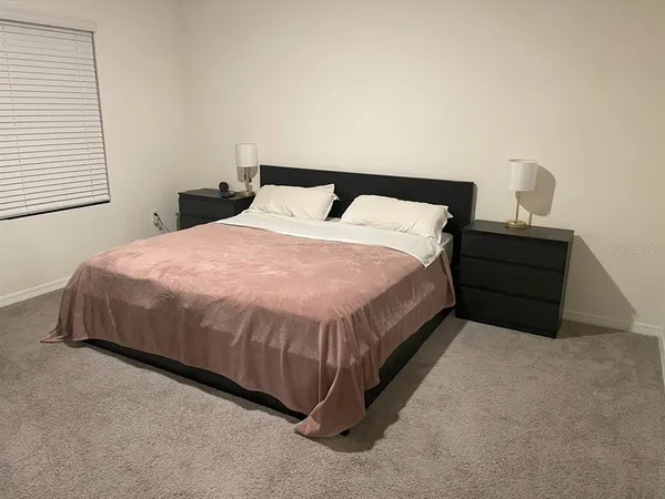 a bedroom with a bed and window