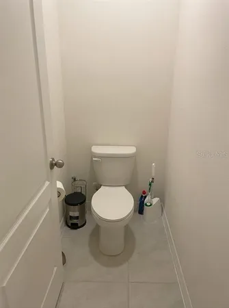 a white toilet sitting next to a white sink