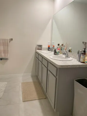a bathroom with a sink vanity and a mirror