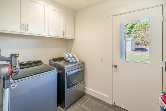 a view of a patio with table and chairs and potted plants