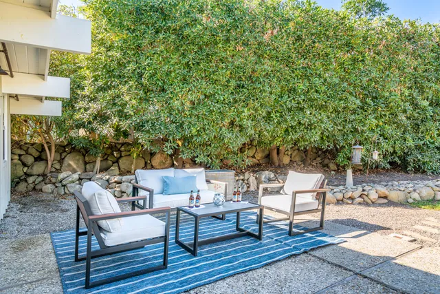 a view of a house with swimming pool and a yard
