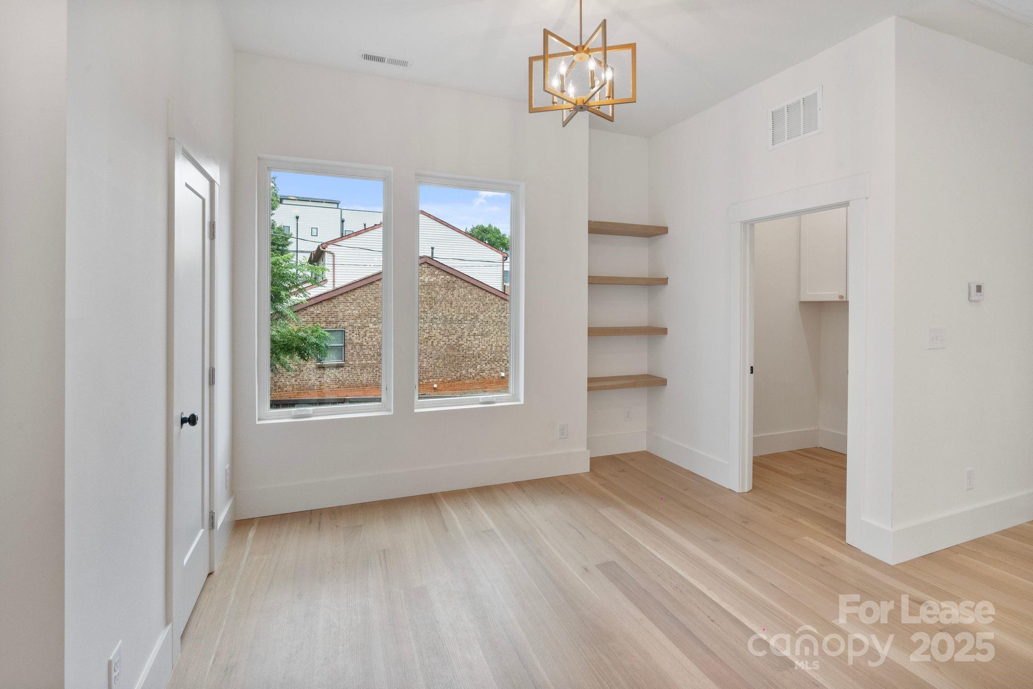 129 French Street, Unit B Charlotte, NC 28216 - Photo 12 of 32 wooden floor in an empty room with a window