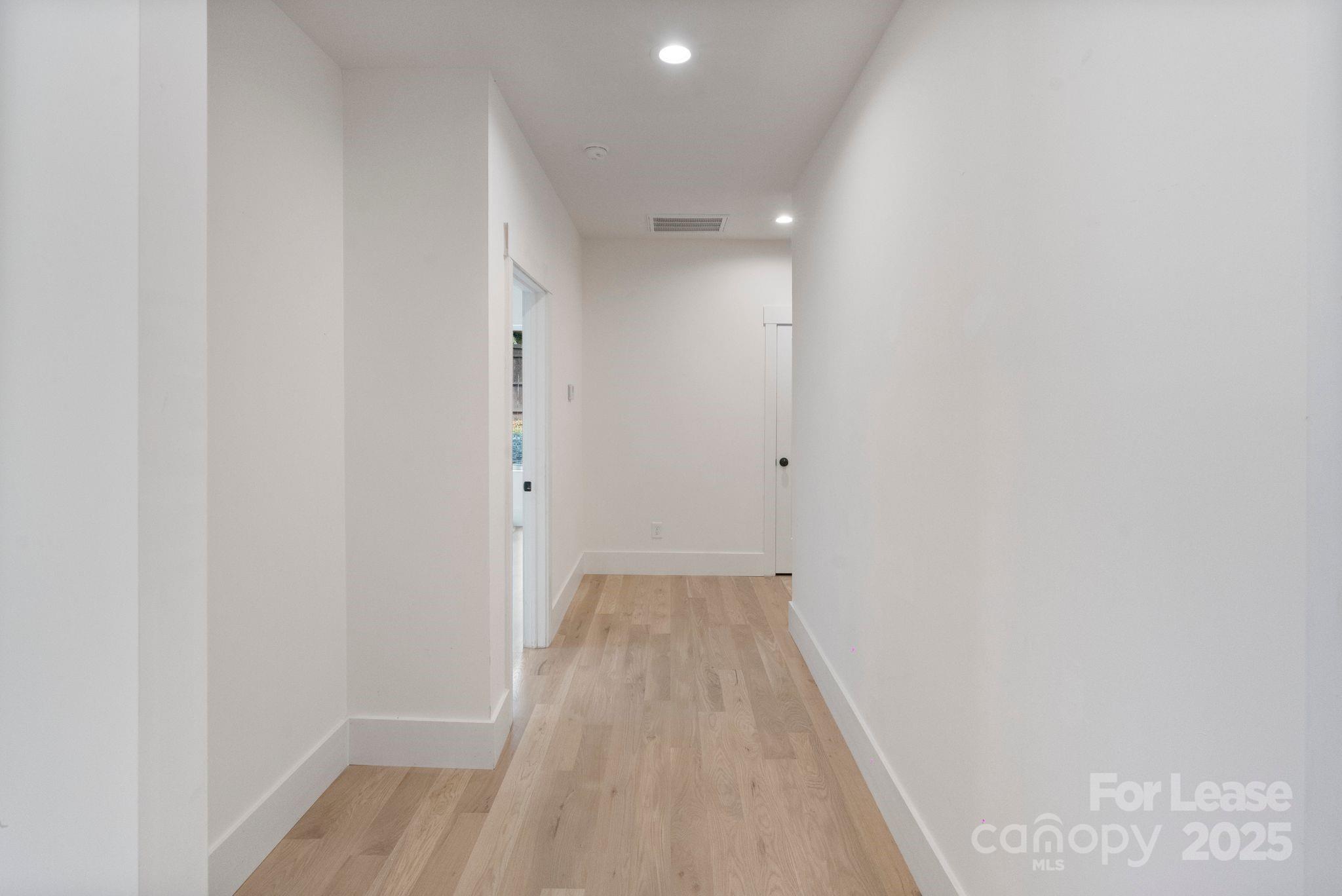 129 French Street, Unit B Charlotte, NC 28216 - Photo 13 of 32 a view of a hallway with wooden floor