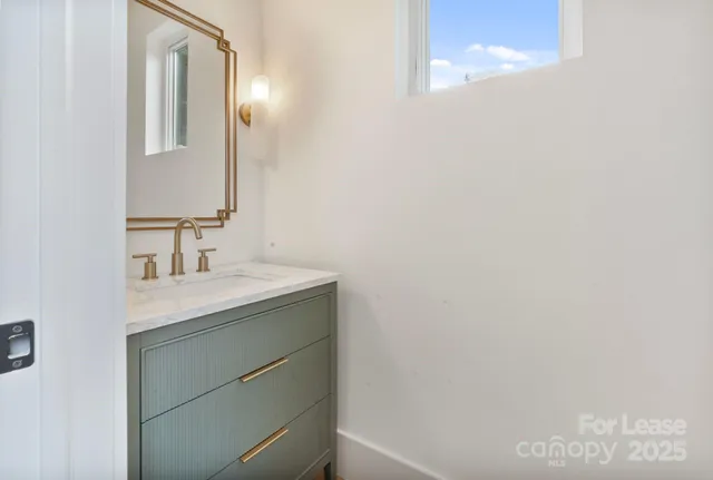 a bathroom with a granite countertop sink mirror and double
