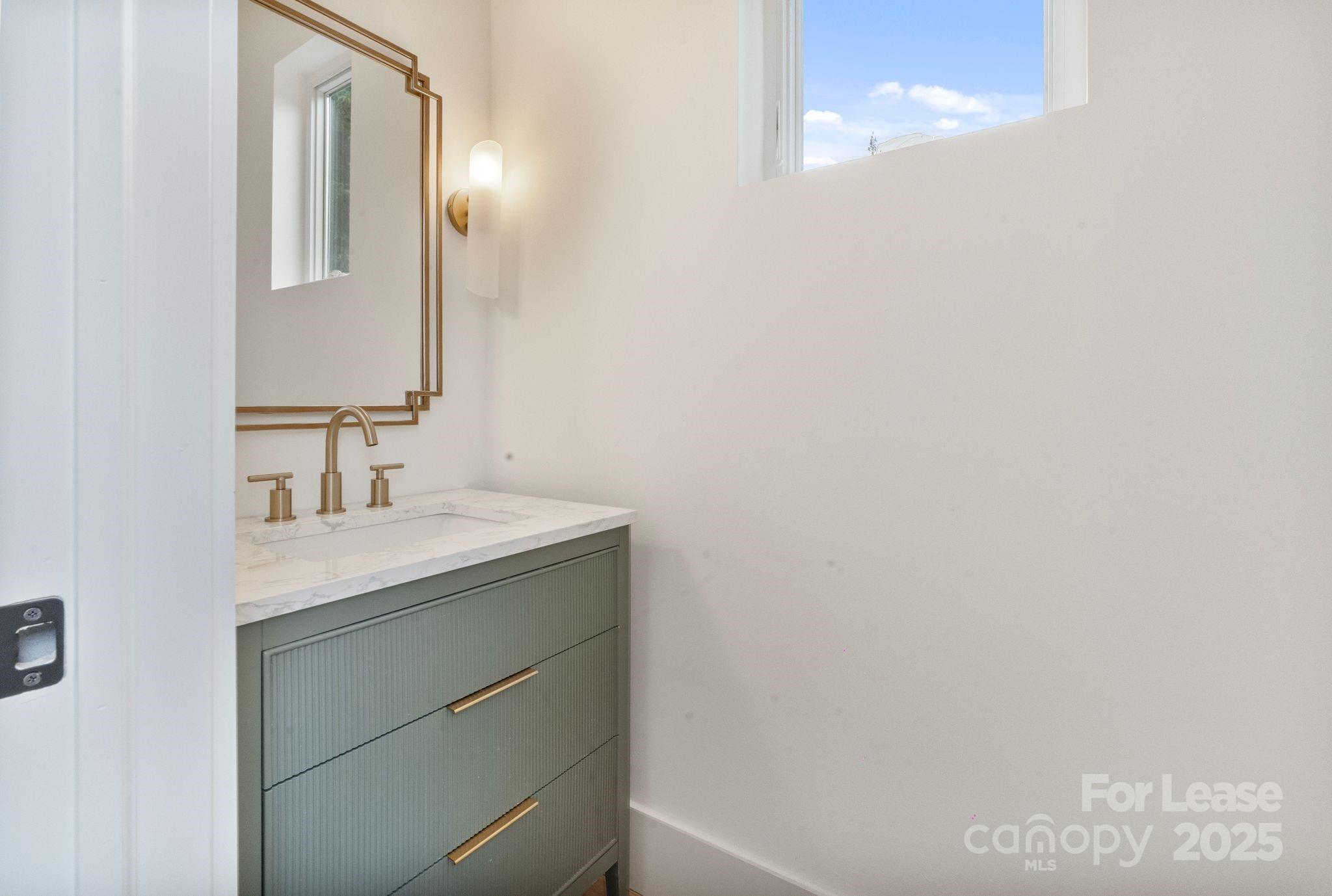 129 French Street, Unit B Charlotte, NC 28216 - Photo 15 of 32 a bathroom with a sink and a mirror