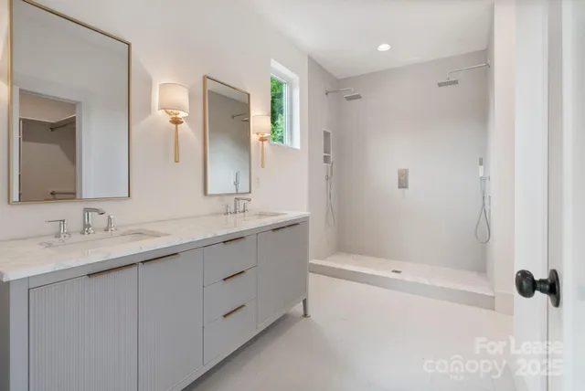 a bathroom with a double vanity sink and a mirror