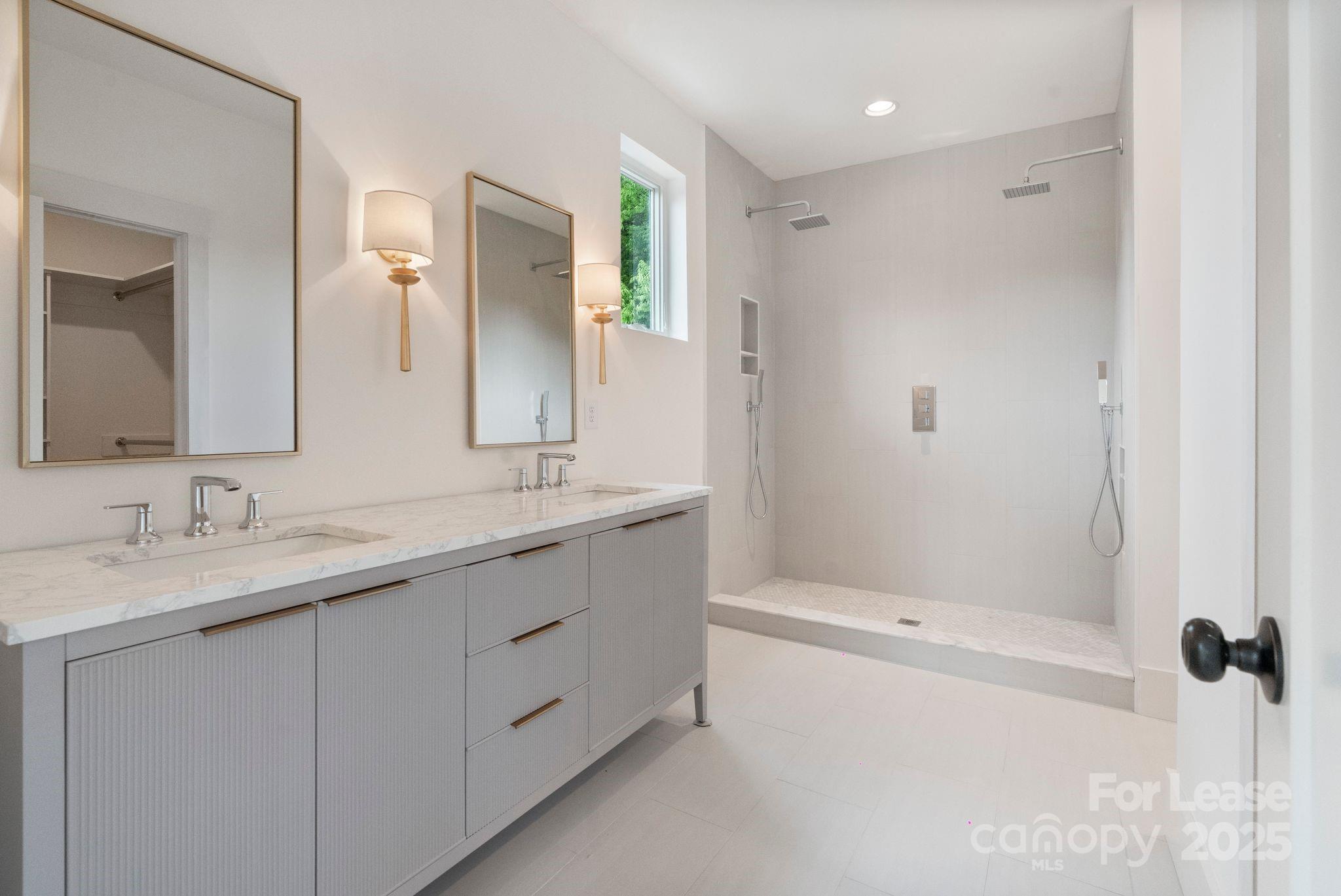 129 French Street, Unit B Charlotte, NC 28216 - Photo 16 of 32 a bathroom with a granite countertop sink mirror and double
