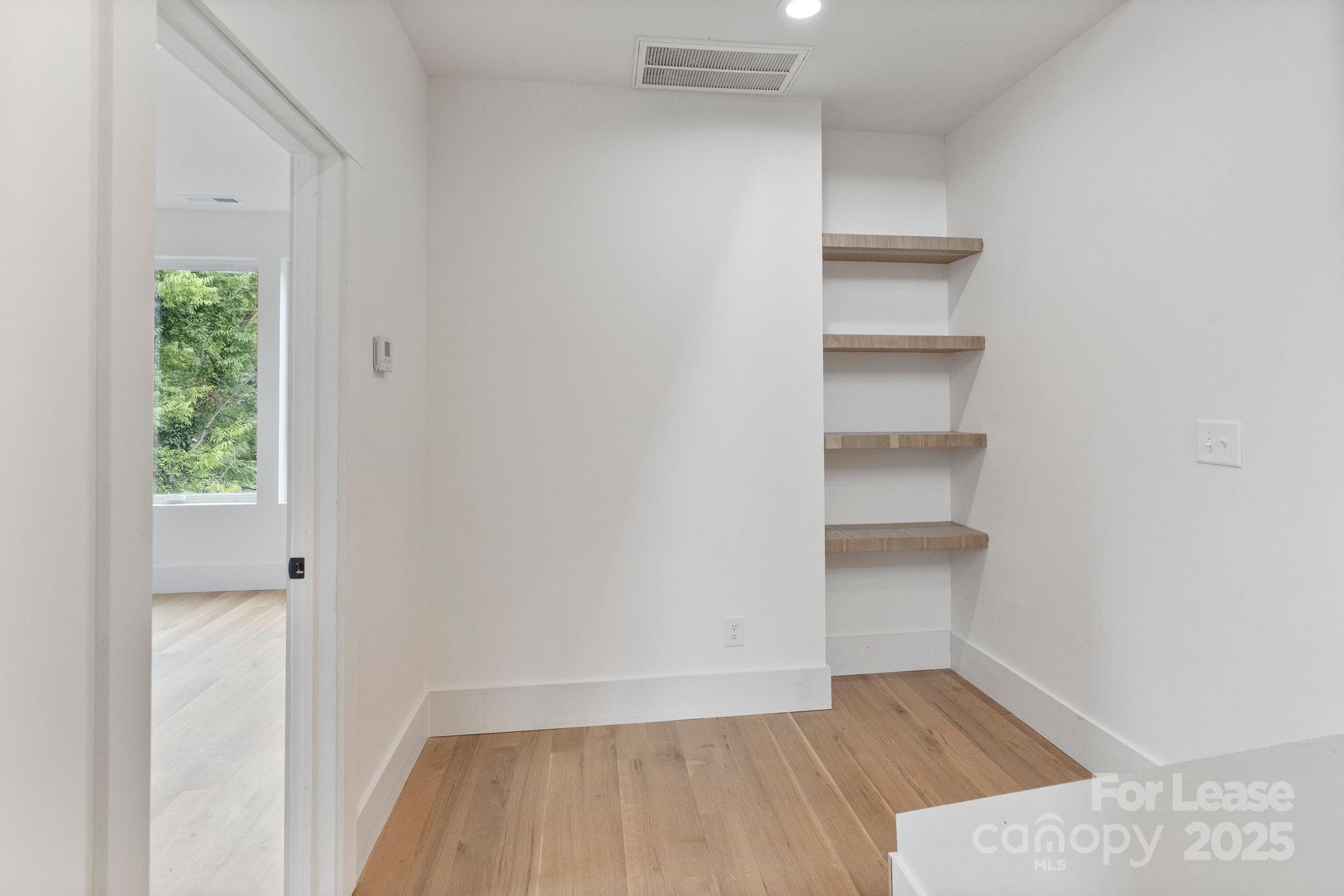 129 French Street, Unit B Charlotte, NC 28216 - Photo 21 of 32 a view of a room with rack on the wall