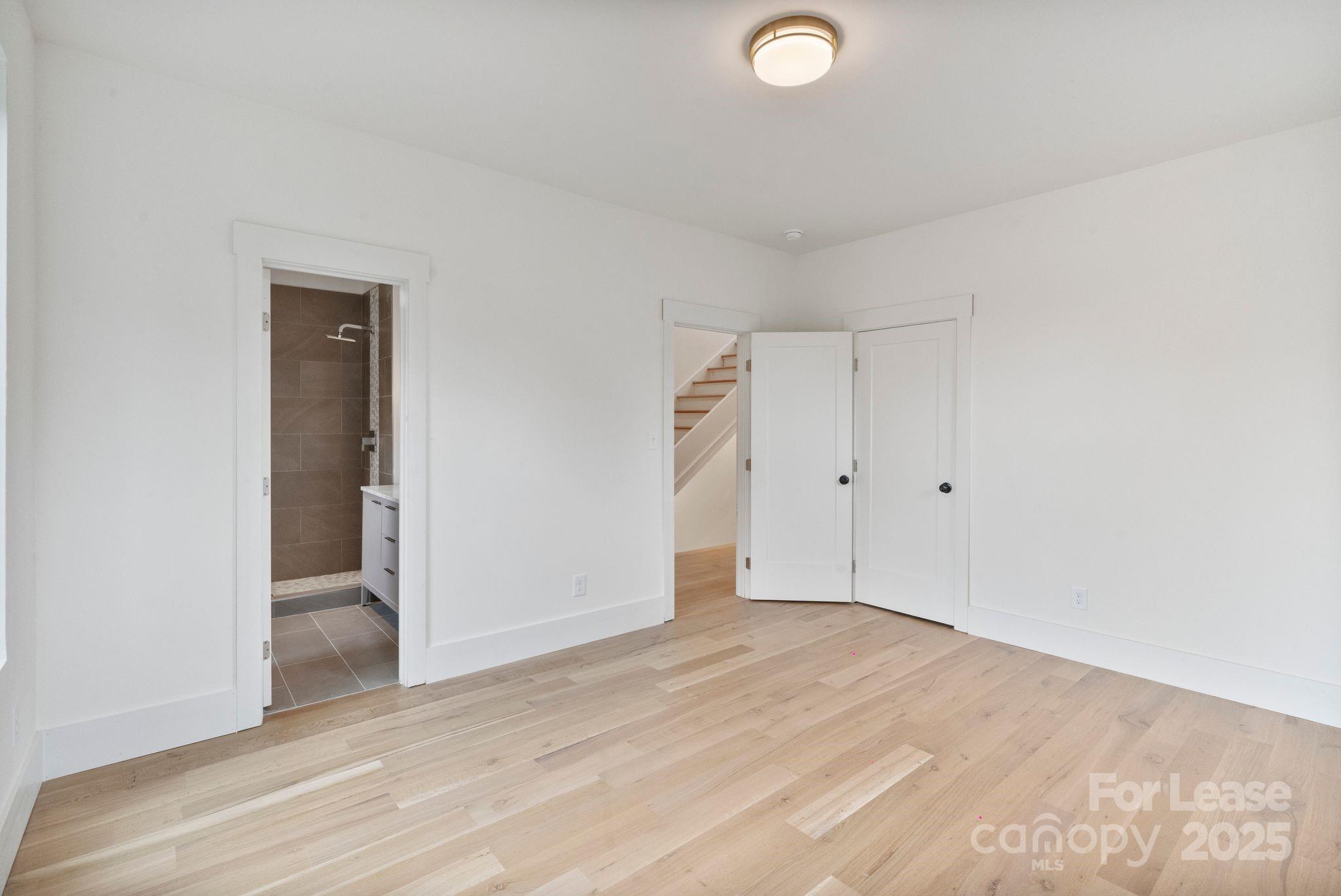 129 French Street, Unit B Charlotte, NC 28216 - Photo 22 of 32 an empty room with wooden floor and windows