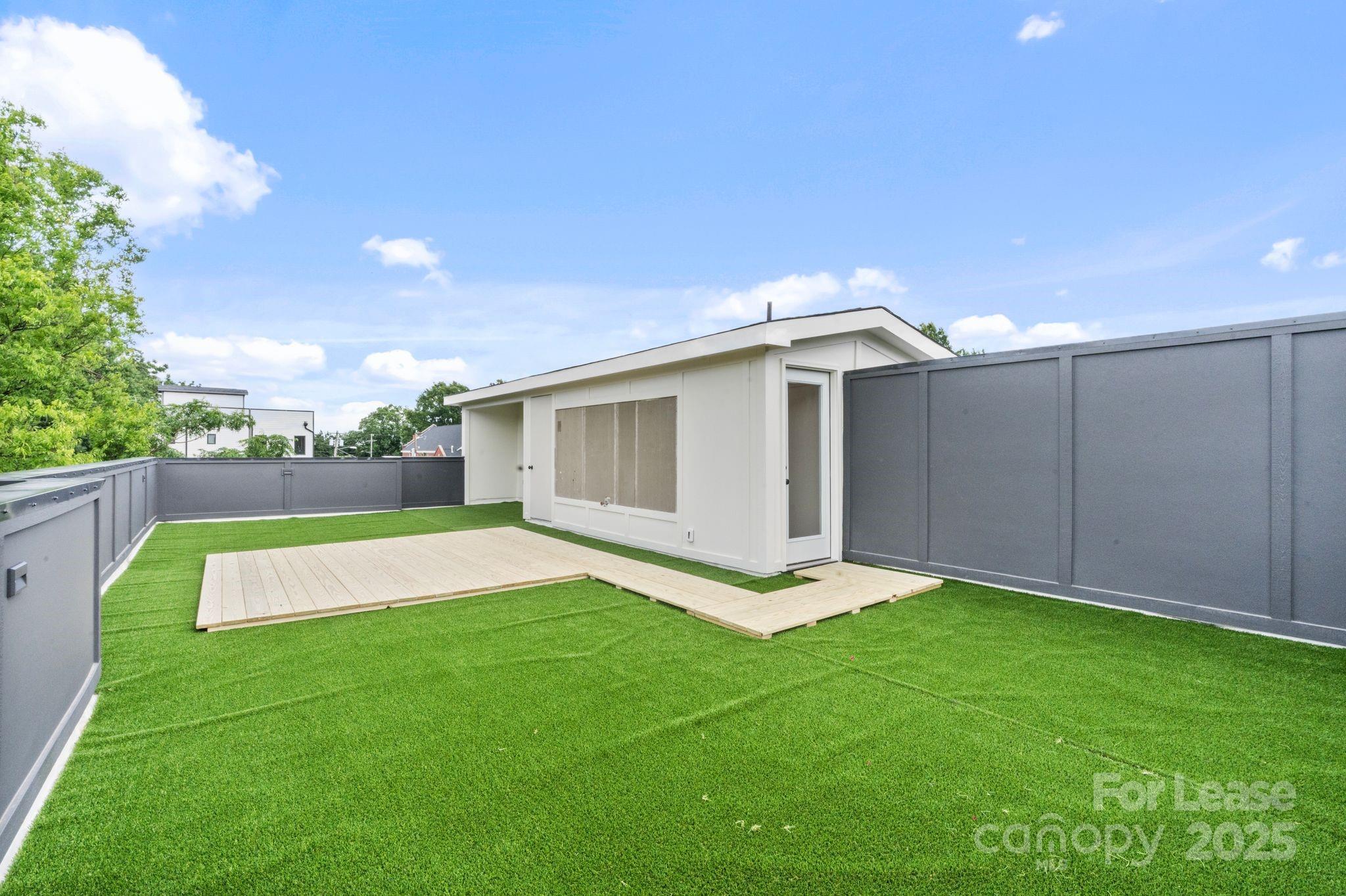 129 French Street, Unit B Charlotte, NC 28216 - Photo 26 of 32 a view of an house with backyard space and balcony