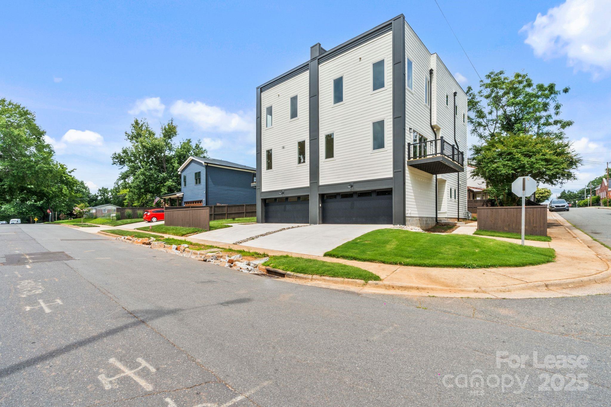 129 French Street, Unit B Charlotte, NC 28216 - Photo 30 of 32 a view of street along with house and trees in the background