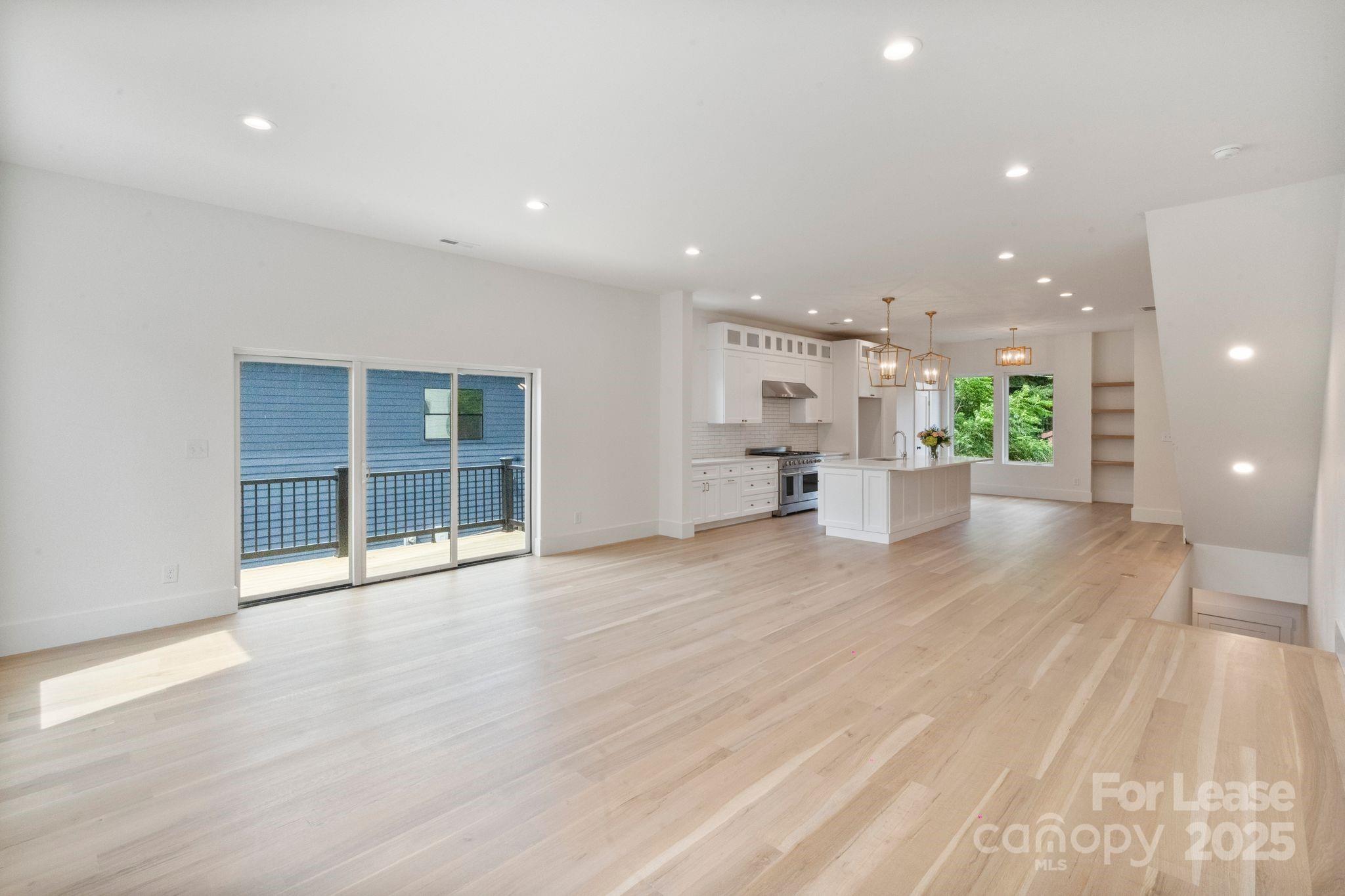 129 French Street, Unit B Charlotte, NC 28216 - Photo 4 of 32 a view of a big room with wooden floor and windows