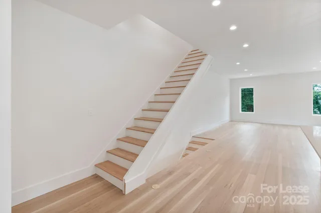 a view of an entryway with wooden floor
