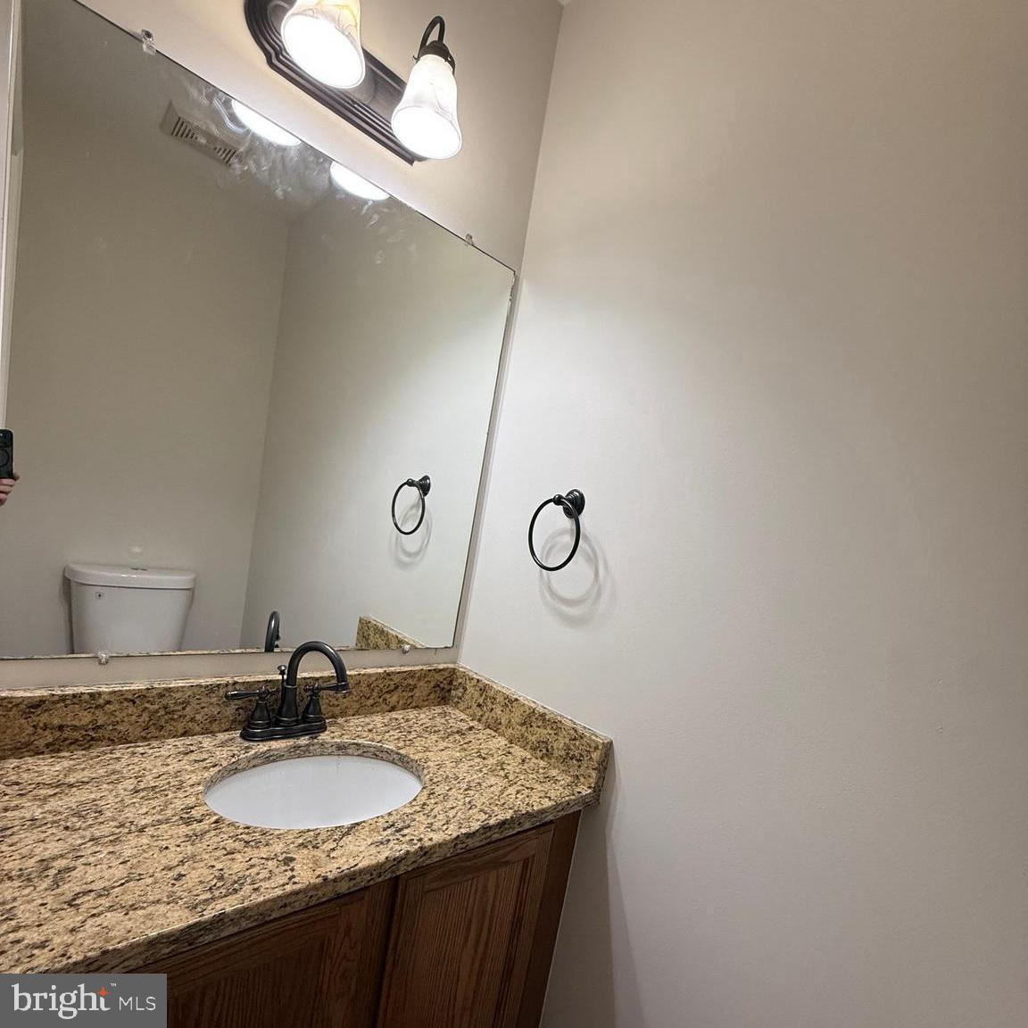 8442 Springfield Oaks Drive Springfield, VA 22153 - Photo 8 of 31 a bathroom with a granite countertop sink and a mirror