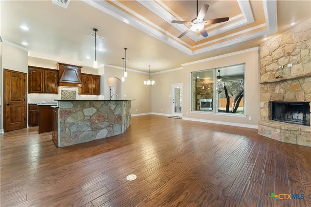 a view of a kitchen with a sink and a fireplace
