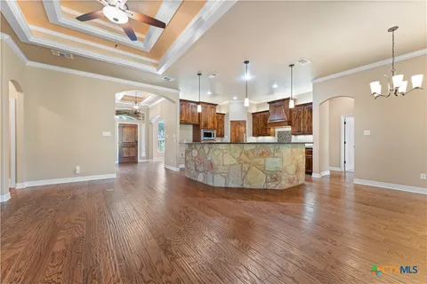 a view of a living room and kitchen with furniture floor to ceiling window