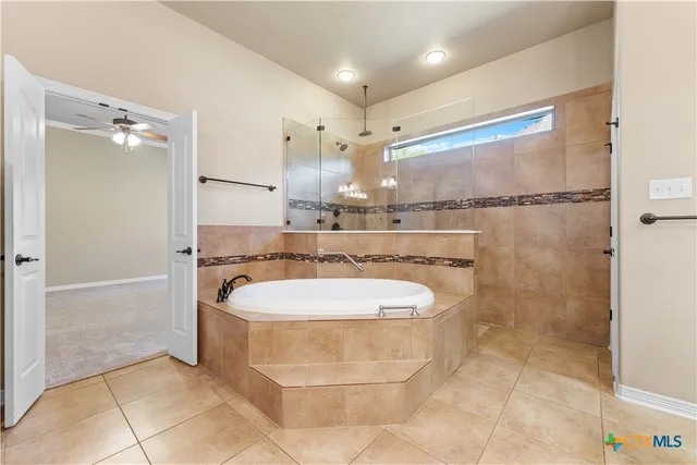 a bathroom with a bathtub and a shower