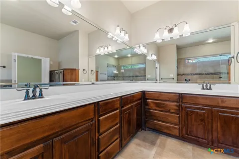 a bathroom with a sink double vanity and a mirror