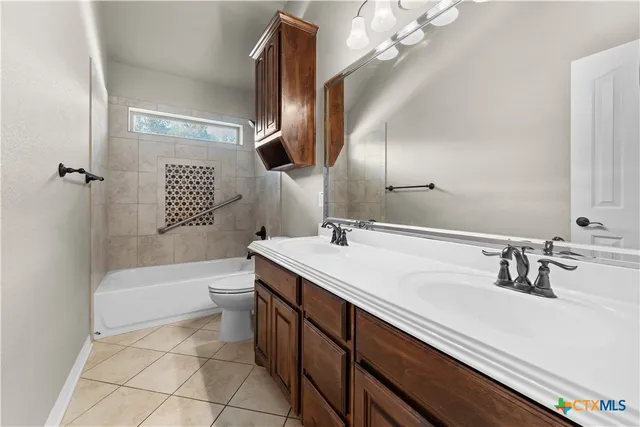 a bathroom with a sink a toilet and bathtub