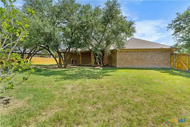 a big yard with tree in front of it