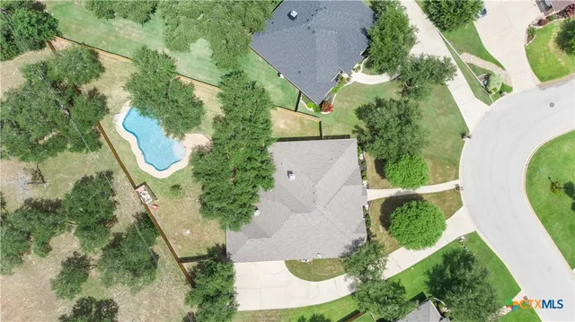 an aerial view of a house with outdoor space