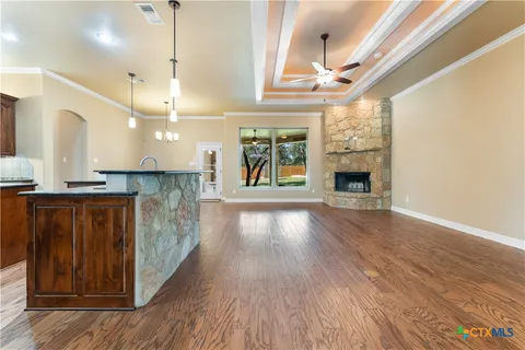 a open kitchen with cabinets and wooden floor