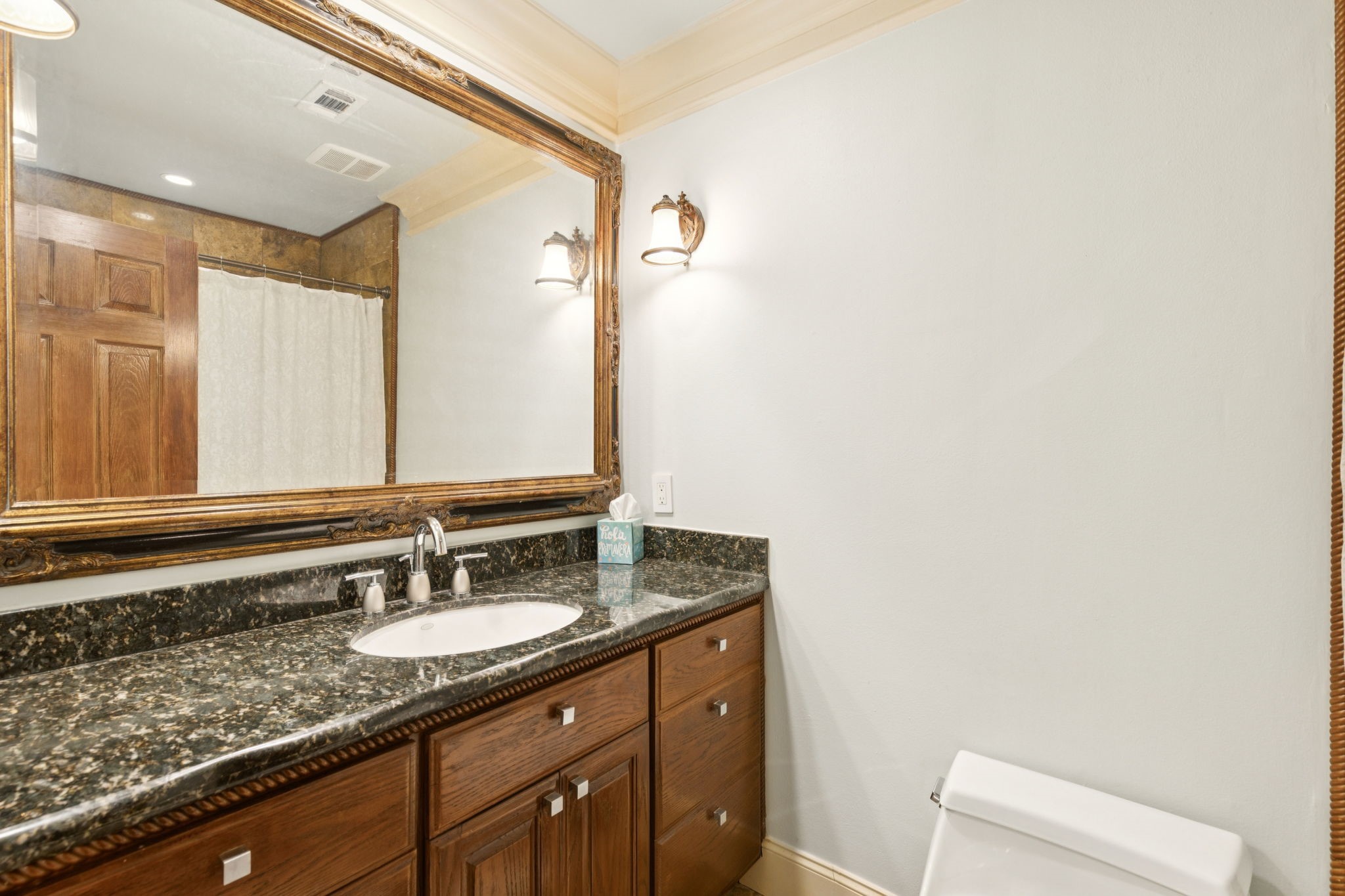 172 Litchfield Lane Houston, TX 77024 - Photo 12 of 16 a bathroom with a granite countertop sink and a mirror