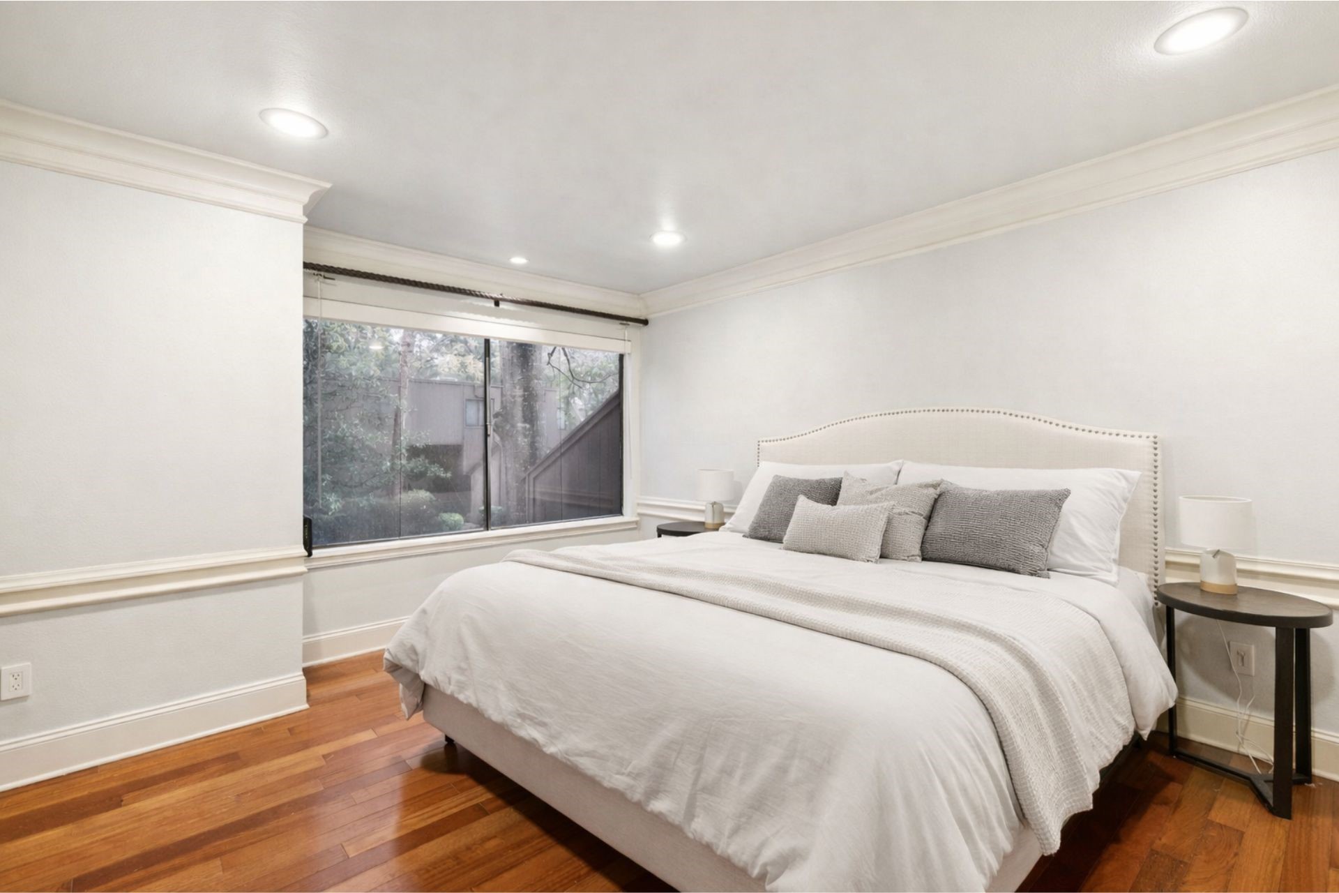 172 Litchfield Lane Houston, TX 77024 - Photo 7 of 16 a large bed sitting in a bedroom next to a window