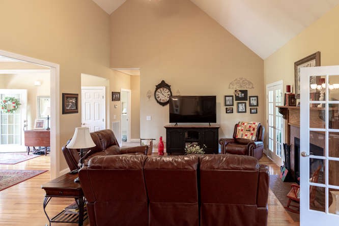 1997 Clara Mathis Road Spring Hill, TN 37174 - Photo 11 of 47 a living room with furniture a flat screen tv and a fireplace