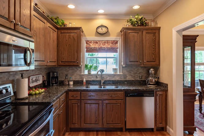 1997 Clara Mathis Road Spring Hill, TN 37174 - Photo 15 of 47 a kitchen with stainless steel appliances granite countertop a sink and cabinets