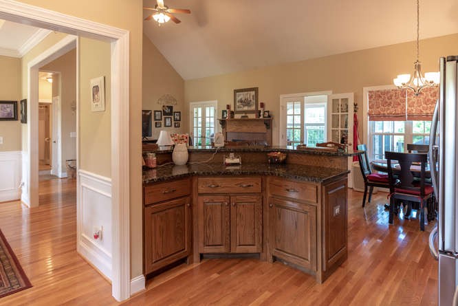 1997 Clara Mathis Road Spring Hill, TN 37174 - Photo 16 of 47 a kitchen with stainless steel appliances granite countertop a stove a refrigerator a sink dishwasher and a fireplace with wooden floor
