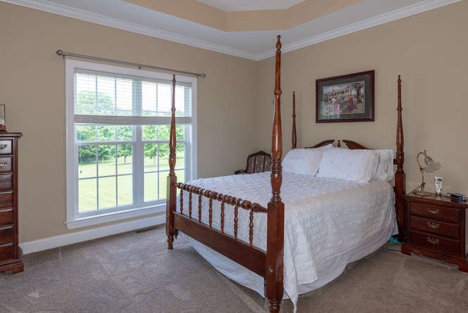 1997 Clara Mathis Road Spring Hill, TN 37174 - Photo 20 of 47 a bed sitting in a bedroom next to a window