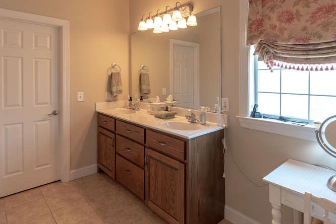 1997 Clara Mathis Road Spring Hill, TN 37174 - Photo 23 of 47 a bathroom with a sink a mirror and a window
