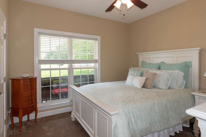 1997 Clara Mathis Road Spring Hill, TN 37174 - Photo 29 of 47 a bedroom with a bed and a chandelier